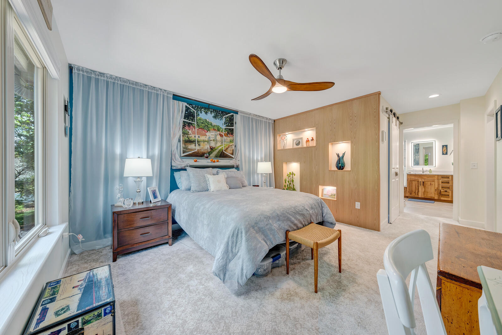 Grace Alon Builders custom bedroom in Smith Mountain Lake featuring built-in shelving and scenic window mural