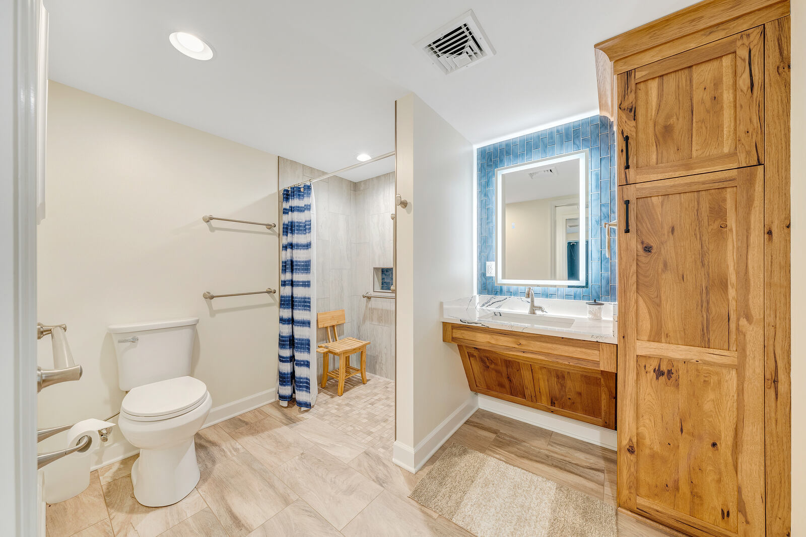 Smith Mountain Lake bathroom remodel by Grace Alon Builders featuring accessible walk-in shower and blue tile